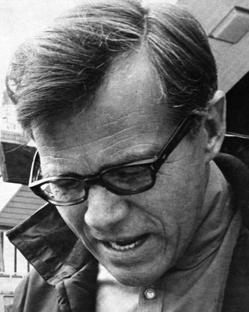 One b/w photograph of Tage Pedersen, 1960-.  He is wearing eyeglasses and looking downward.